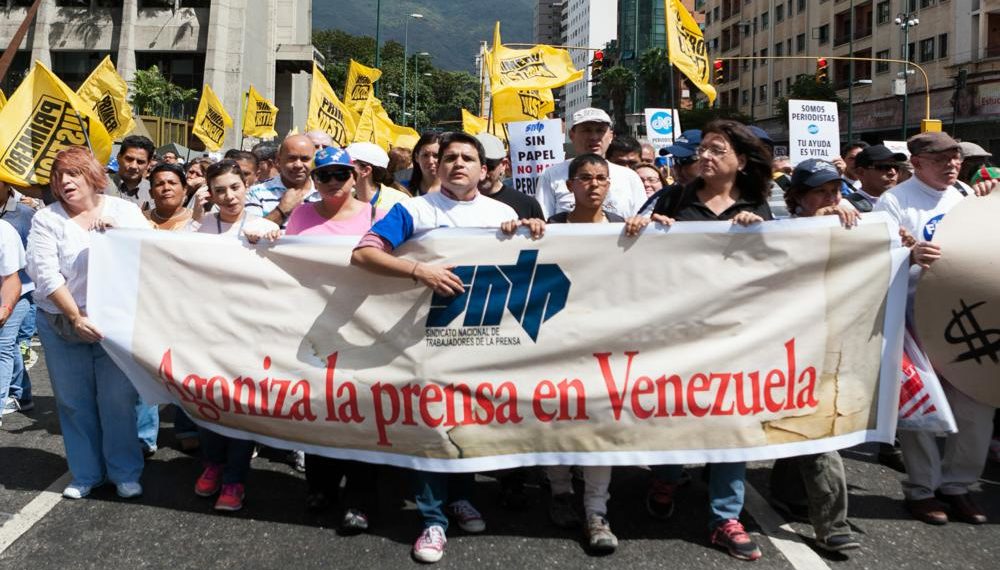 CAR19 CARACAS (VENEZUELA),11/02/2014.- Manifestantes del Sindicato Nacional de Trabajadores de la Prensa (SNTP) protestan hoy, martes 11 de febrero del 2014, en Caracas (Venezuela). Secundados por dirigentes de la oposición, trabajadores de la prensa venezolana marcharon en la capital en defensa de sus puestos de trabajo, que consideran en peligro debido al atraso oficial en la entrega de divisas para importar papel periódico. EFE/SANTI DONAIRE